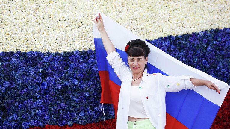 Женщина на фоне триколора из бутонов живых роз в День России в Краснодаре